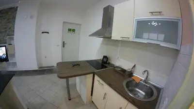 a small kitchen with a sink and a microwave at Cozy Quiet Apartment Nis in Niš