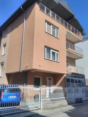 a building with a fence in front of it at Cozy Quiet Apartment Nis in Niš