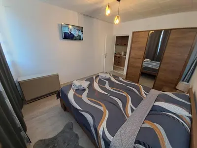 a bedroom with a large bed in a room at Hedonic apartment in Ćuprija