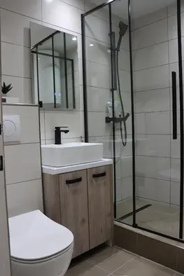 a bathroom with a toilet and a sink and a shower at Hedonic apartment in Ćuprija