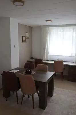 a room with a table and chairs and a window at Hedonic apartment in Ćuprija
