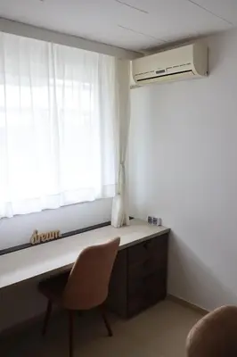 a room with a desk and a window and a chair at Hedonic apartment in Ćuprija