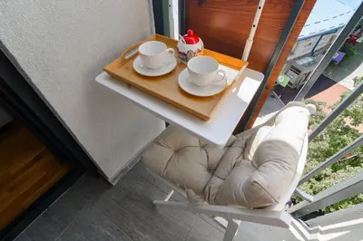 a table with two cups and saucers on it at Gracija in Jagodina
