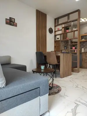 a living room with a couch and a table at Cera exclusive apartment in Soko Banja