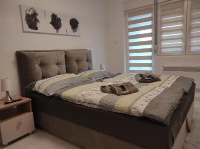 a bed with two towels on it in a bedroom at Cera exclusive apartment in Soko Banja