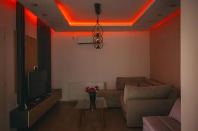 a living room with a couch and a tv at Apartman Dias in Niš