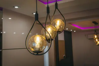 a group of lights hanging from a ceiling at Apartman Dias in Niš