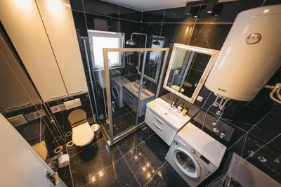 a bathroom with a white sink and a mirror at Apartman Dias in Niš
