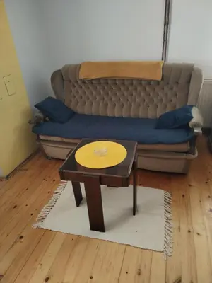 a living room with a couch and a coffee table at Apartman Ristić in Vranje