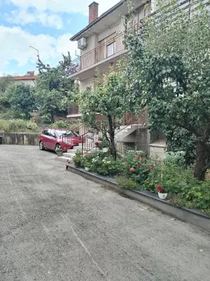 a car parked in a parking lot next to a building at Apartman Ristić in Vranje