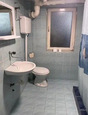 a bathroom with a toilet and a sink at Apartman Ristić in Vranje