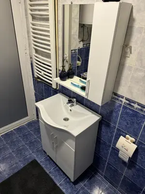 a bathroom with a white sink and a mirror at Loli apartman 2 in Kraljevo