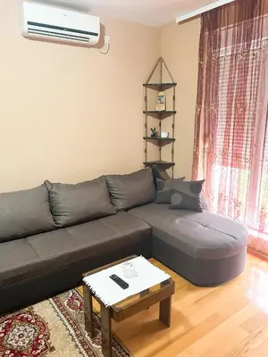 a living room with a couch and a table at Apartman Jasmina Vrnjačka banja in Vrnjačka Banja