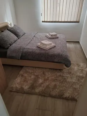 a bedroom with a bed with two towels on it at Apartman Sofija in Vrnjačka Banja