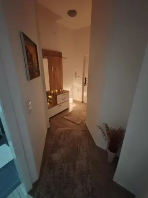 a hallway with a room with a dresser and a door at Apartman Sofija in Vrnjačka Banja