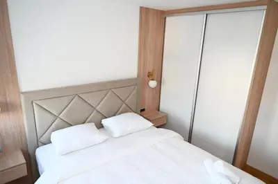 a bedroom with a white bed with two white pillows at Apartman Vera 8 VRNJAČKA BANJA in Vrnjačka Banja