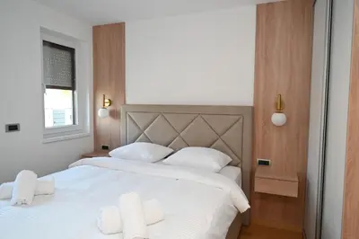 a bedroom with two beds with white sheets at Apartman Vera 8 VRNJAČKA BANJA in Vrnjačka Banja