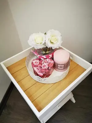 a table with a cake and flowers on it at Apartman LUKA 2 in Soko Banja
