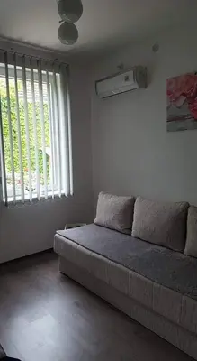 a living room with a couch and a window at Apartman LUKA 2 in Soko Banja
