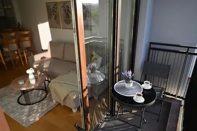 a living room with a couch and a table at Apartman Lokica S Vrnjačka Banja in Vrnjačka Banja