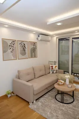 a living room with a couch and a table at Apartman Lokica S Vrnjačka Banja in Vrnjačka Banja