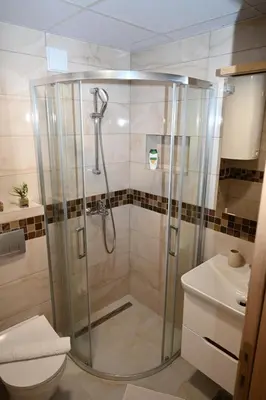 a bathroom with a shower with a toilet and a sink at Apartman Lokica S Vrnjačka Banja in Vrnjačka Banja
