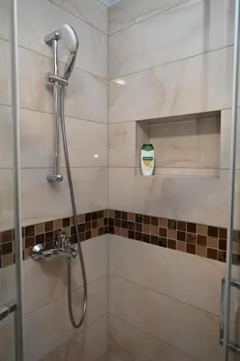 a shower with a shower head in a bathroom at Apartman Lokica S Vrnjačka Banja in Vrnjačka Banja