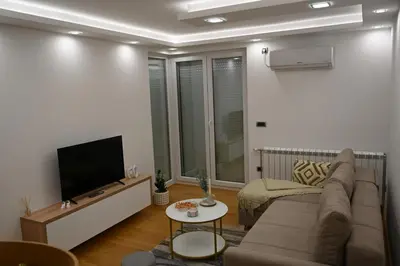 a living room with a couch and a flat screen tv at Apartman Aleksa 5 VRNJAČKA BANJA in Vrnjačka Banja