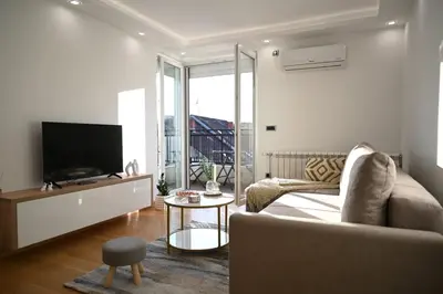 a living room with a couch and a tv at Apartman Aleksa 5 VRNJAČKA BANJA in Vrnjačka Banja