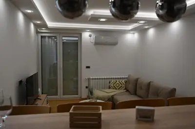 a living room with a couch and a tv at Apartman Aleksa 5 VRNJAČKA BANJA in Vrnjačka Banja