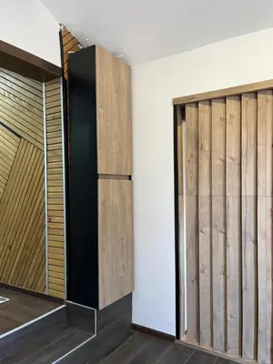 a room with a closet with wooden doors at DeFakto in Vrnjačka Banja