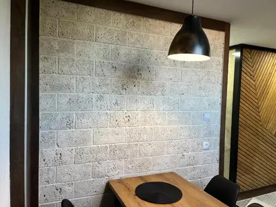 a table with a hat on top of a brick wall at DeFakto in Vrnjačka Banja