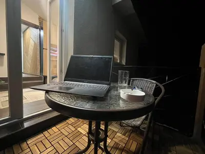 a laptop computer sitting on a table in a room at DeFakto in Vrnjačka Banja