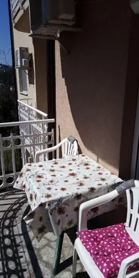 a table and chairs sitting on a balcony with a table and chairs at Apartman Sanja in Vrnjačka Banja