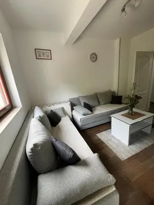a living room with a couch and a table at Apartman Sanja 2 in Vrnjačka Banja