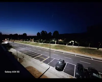 a parking lot with cars parked on the side of a road at Apartman Centrala in Pirot