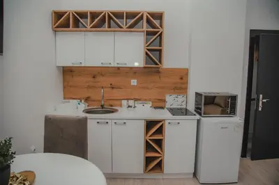 a kitchen with a sink and a refrigerator at Jes Apartments in Leskovac