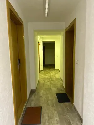 a hallway of an empty room with doors and a floor at 407 Elegant in Vrnjačka Banja