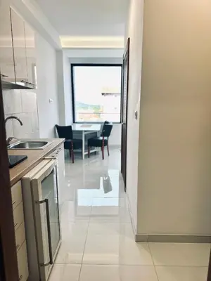 a kitchen with a table and a dining room at 407 Elegant in Vrnjačka Banja