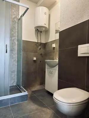 a bathroom with a toilet and a sink and a shower at 407 Elegant in Vrnjačka Banja