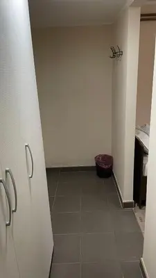 a room with a hallway with a door and a tile floor at Garni Hotel Lion in Jagodina