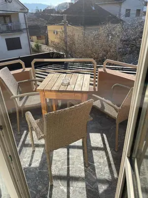 a table and chairs on a balcony with a table and chairs at Garni Hotel Lion in Jagodina