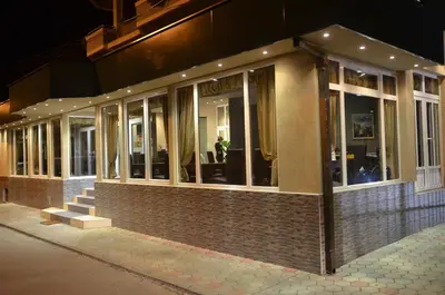 a building with a bunch of windows on a street at Garni Hotel Lion in Jagodina