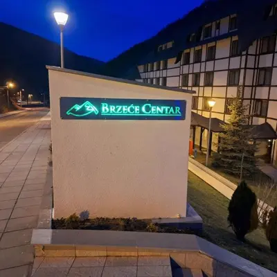 a sign for a building in front of a street at Apartman 22, Brzeće Centar in Mramor