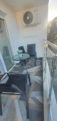 a living room with a table and a chair at Apartman TADEJ & FREE PARKING in Vrnjci