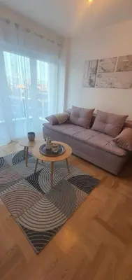 a living room with a couch and a table at Apartman TADEJ & FREE PARKING in Vrnjci