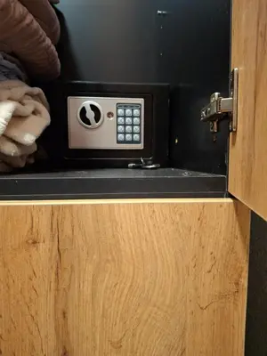a microwave oven sitting on top of a wooden cabinet at A&S Apartments Nis in Niš