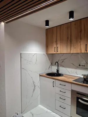 a kitchen with white marble counters and a sink at A&S Apartments Nis in Niš