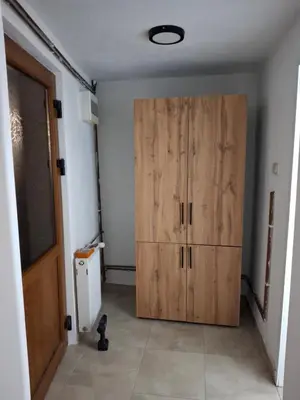 a large wooden cabinet in a room with a door at A&S Apartments Nis in Niš