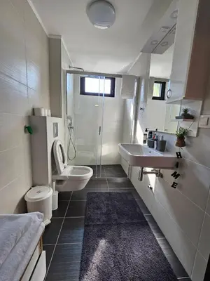 a bathroom with a toilet and a sink at Apartman KING CENTAR in Vrnjačka Banja